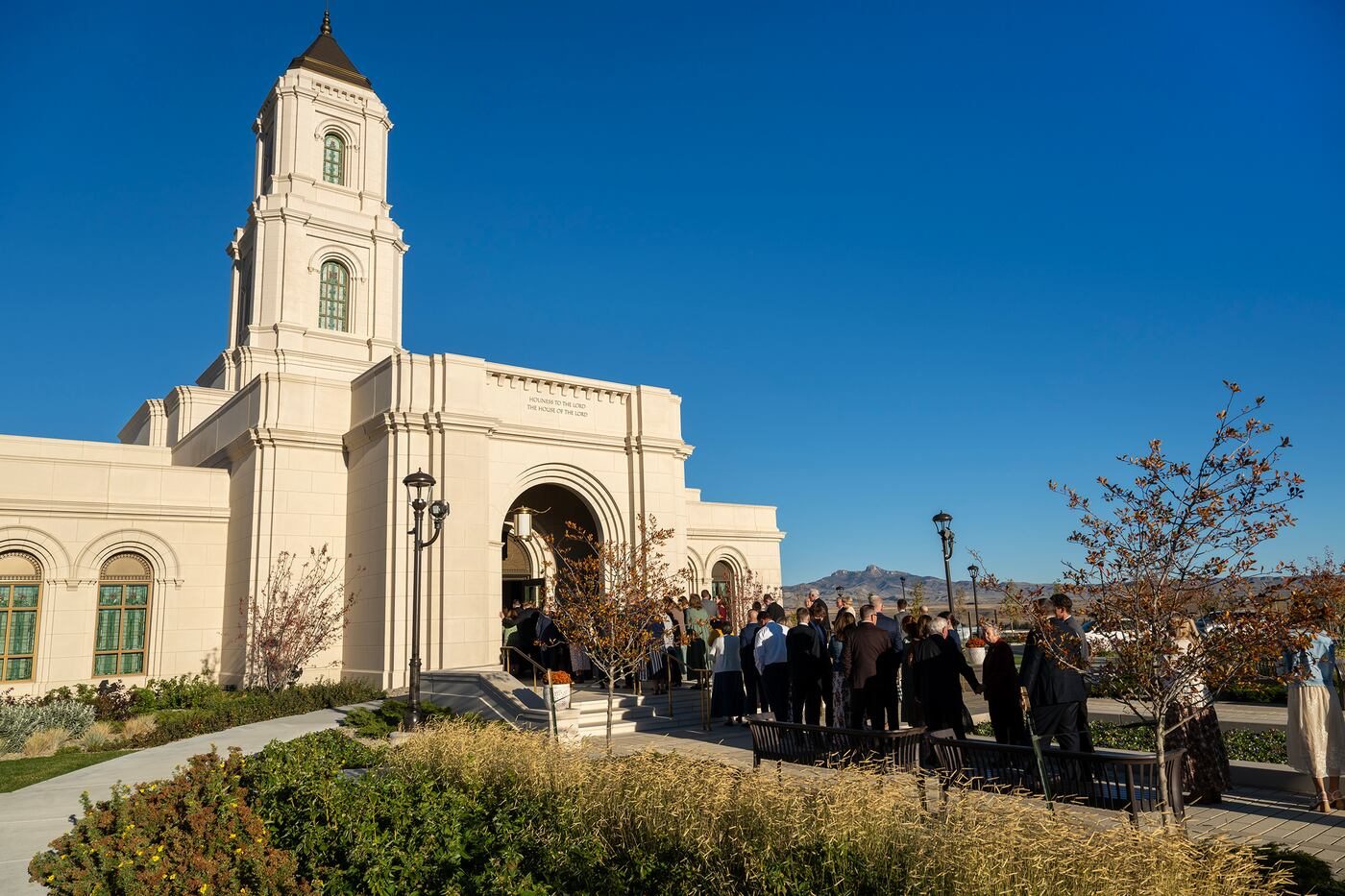 Church members walking toward the white Cody Wyoming Temple and its tower on dedication day