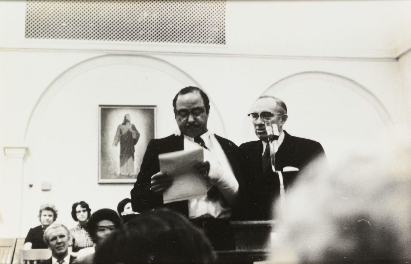 Historical black-and-white photo of the first meeting of the Genesis Group