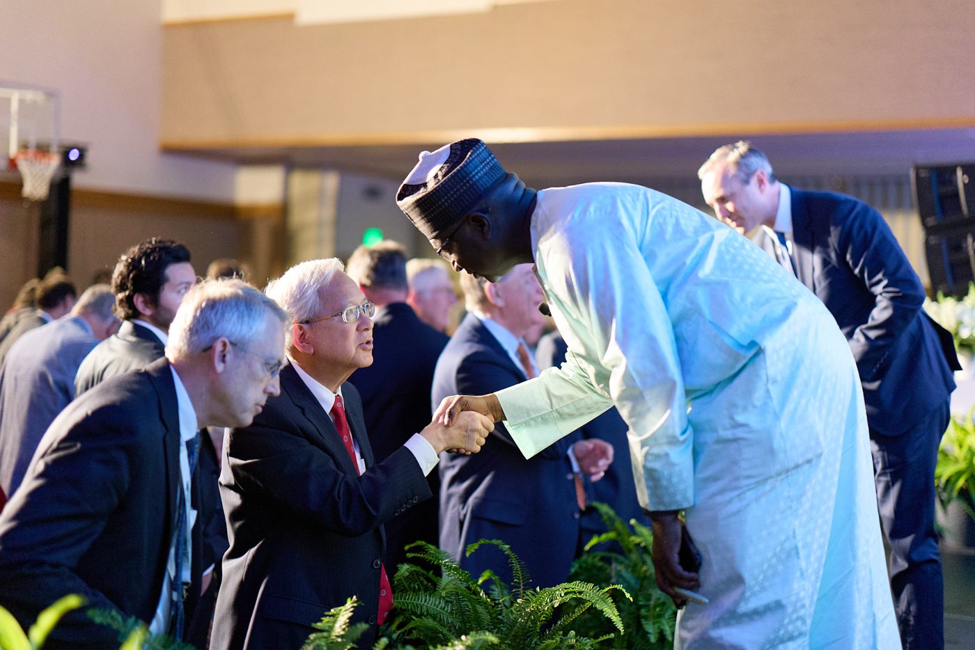 Elder Gong greeting a faith leader in white robes at the G20 Interfaith Forum