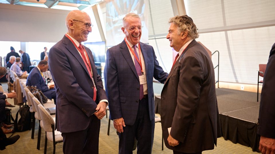 Church leaders greeting a guest at the Forum on Faith in New York City