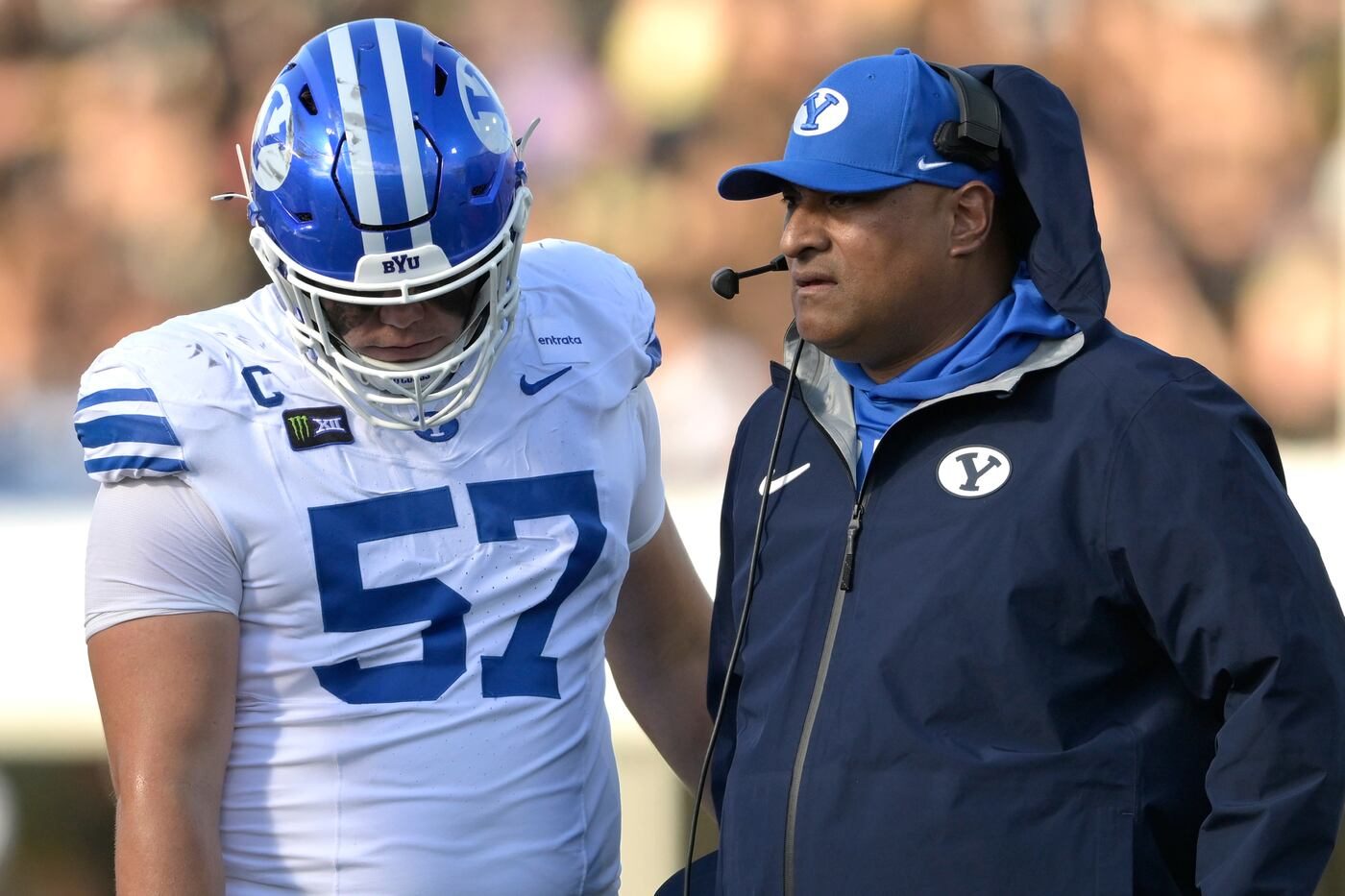 BYU coach Kalani Sitake talks with defensive tackle Keanu Tanuvasa on the sideline at UCF