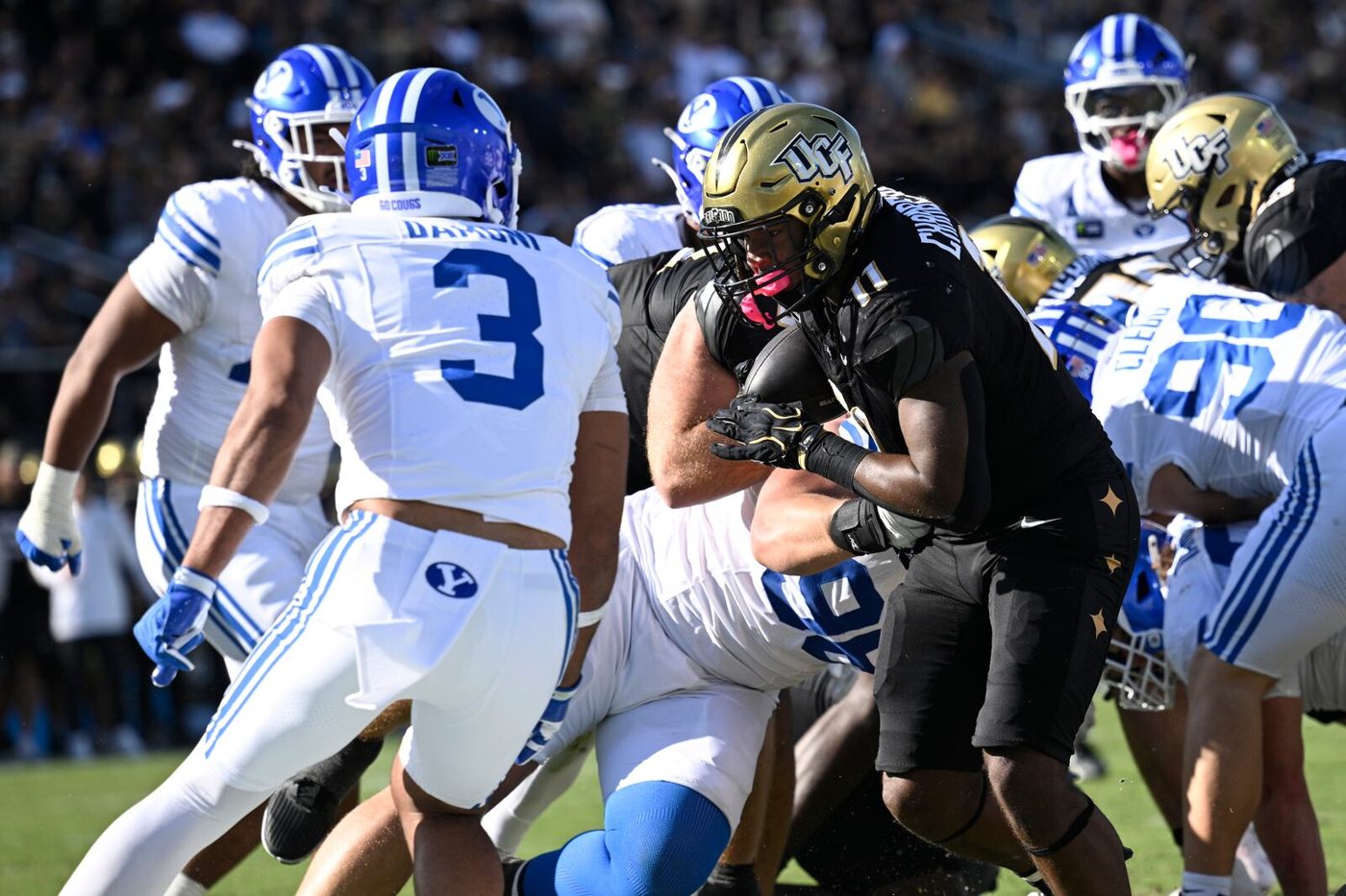 UCF running back Landen Chambers scoring a touchdown in front of BYU safety Raider Damuni