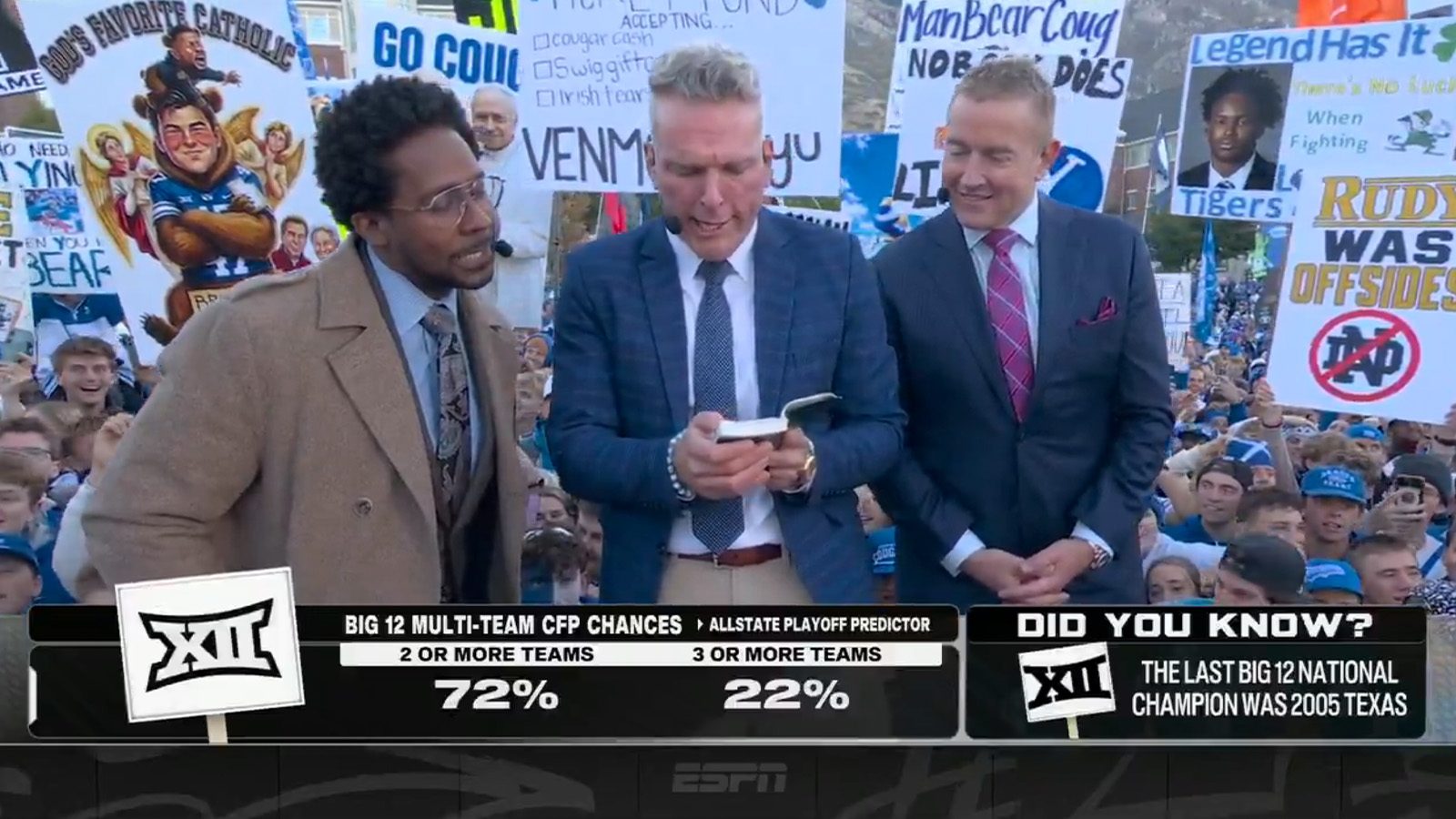 Pat McAfee reading from a small Book of Mormon on the College GameDay set in Provo